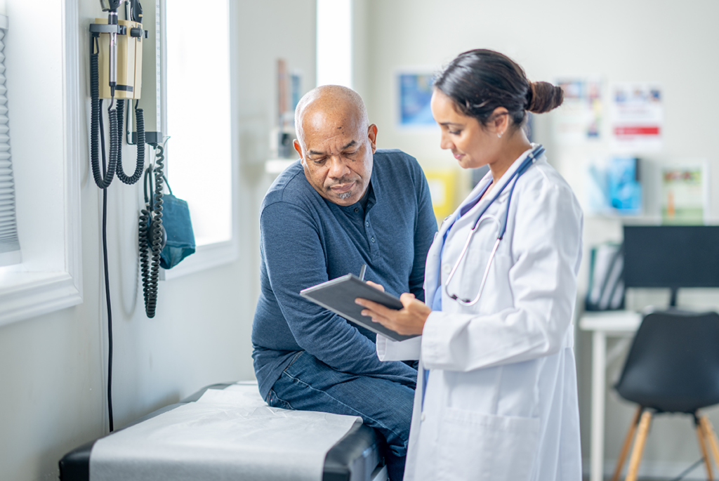 endocrinologist speaking with patient looking at tablet