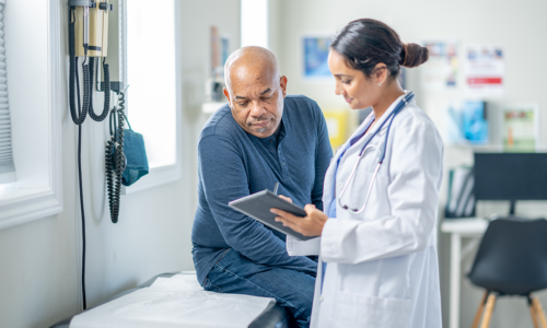 endocrinologist speaking with patient looking at tablet